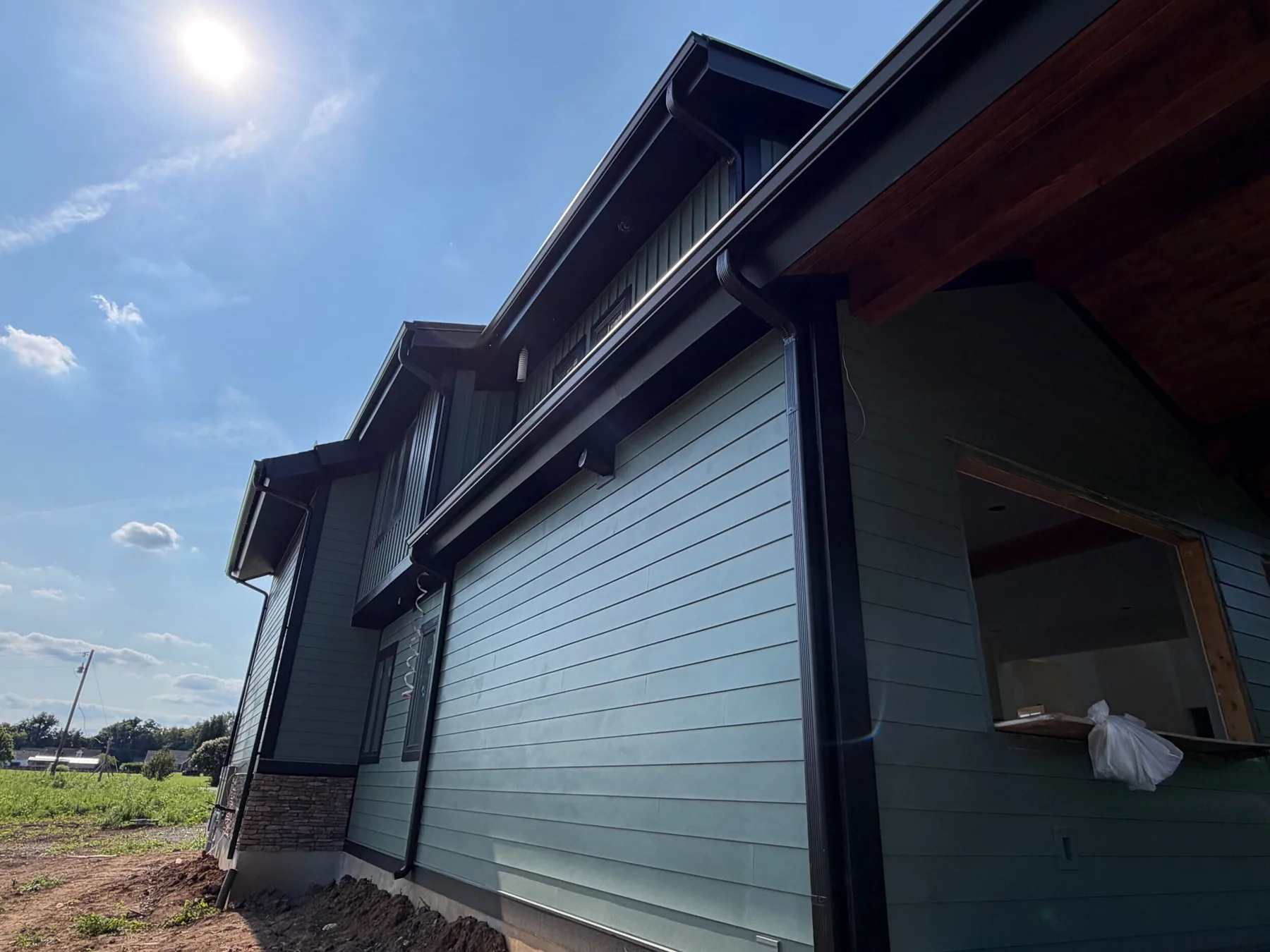 Finished home exterior with new siding, gutters and trim