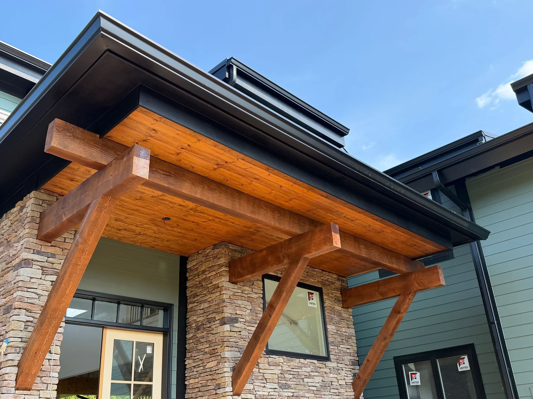 Completed porch, roof, gutters, siding and exterior trim on an actual project